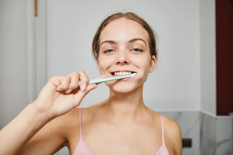 Woman brushing teeth
